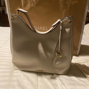 Brand new Michael Kors large Tote still has original tags comes w/MK cloth bag